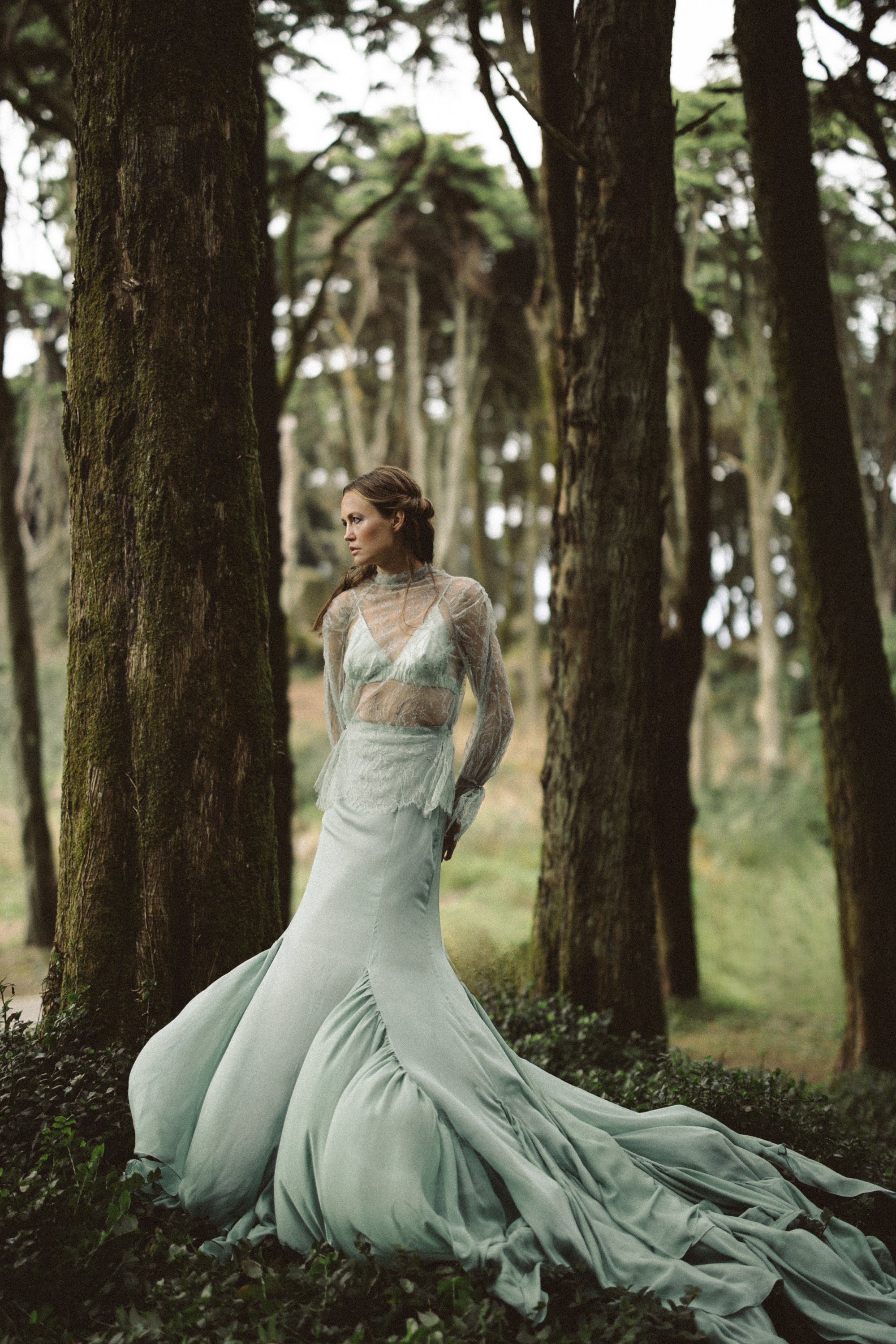 Model wearing Miryelle ethereal wedding lace top with high neckline and silk chiffon skirt — full-length bridal separate styled in forest by MYWONY