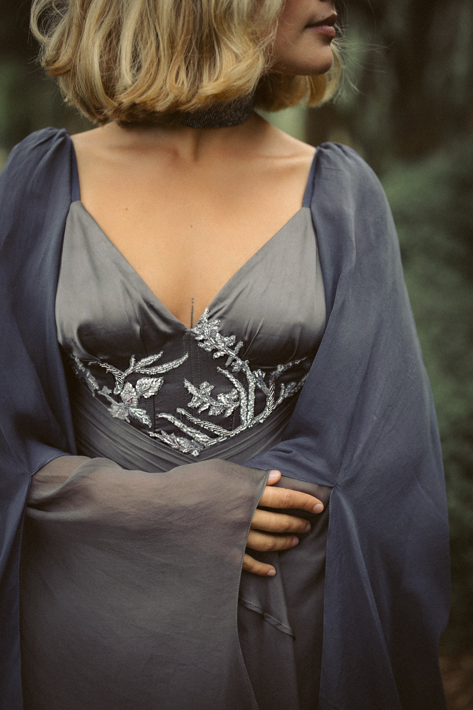 Vea ethereal wedding dress — close-up of V-neck bodice with beaded lace embroidery on grey chiffon, handcrafted bridal gown by MYWONY