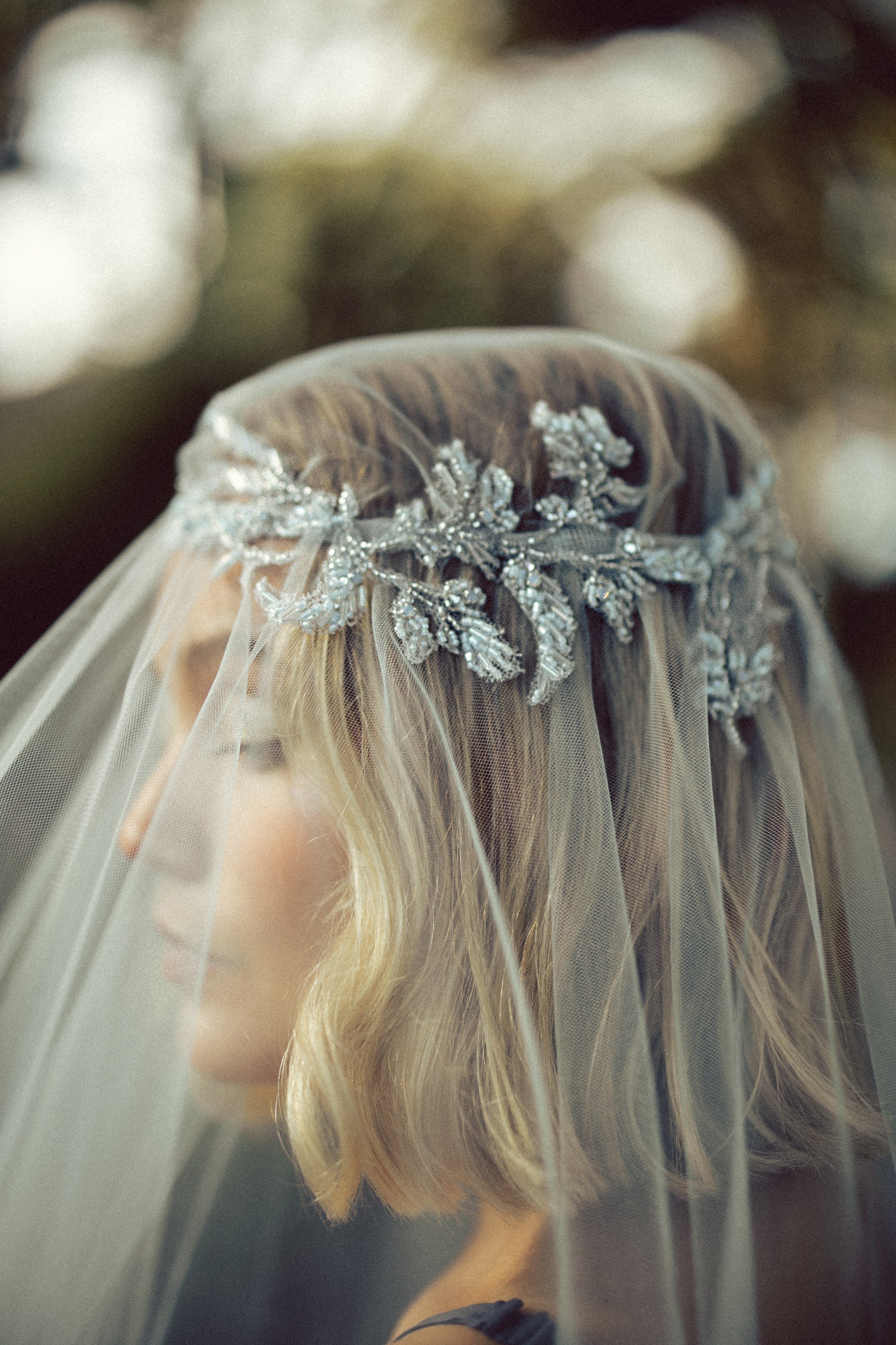 Close-up of Vea Veil blue-grey beaded lace crown embroidery detail by MYWONY, handcrafted bridal headpiece on ethereal tulle wedding veil